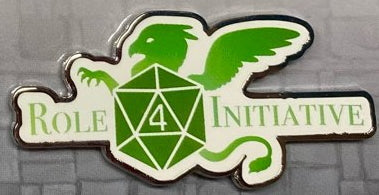 A soft enamel pin depicting the Role 4 Initiative Logo