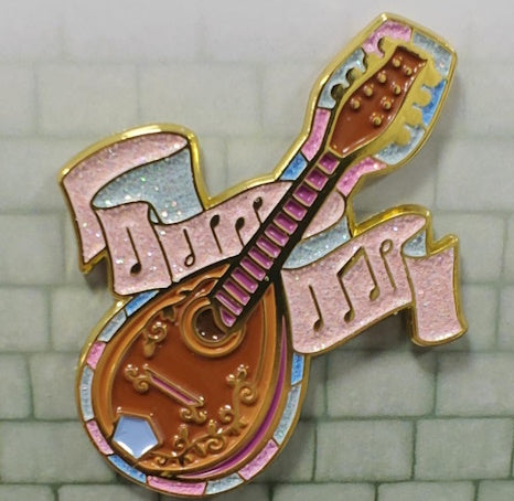 A beautiful enamel pin depicting a Bard's mandolin, complete with pink glittered musical notes representing the magic of music.