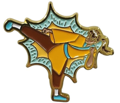 An enamel pin featuring a Monk character in yellow and blue colors with a golden ki outline.