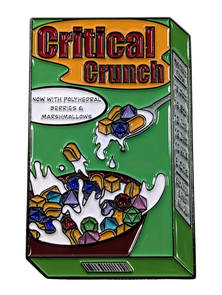 A colorful enamel pin depicting a box of Critical Crunch breakfast cereal with a spoon, now with berries and malted milk. Milk not included.