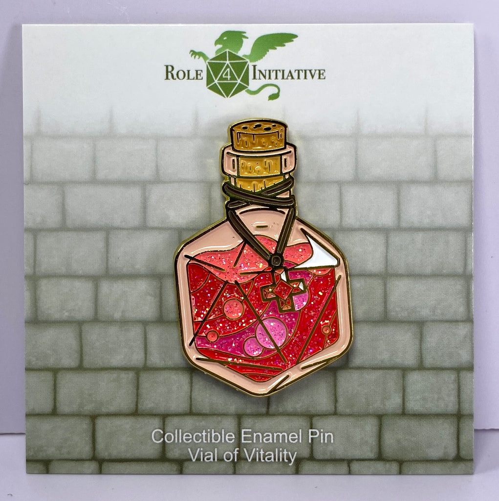Hard enamel pin depicts a d20-shaped health potion bottle in bubbling red and pink hues, with a healing red cross gem draped around the bottle's neck.  Packaged in a polybag with backing card containing description, SKU, and UPC barcode.