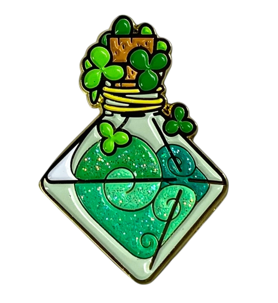 A collectible enamel pin featuring a glittering green pin with a d8-shaped fortuitous vapor bottle design and lucky clovers around it.