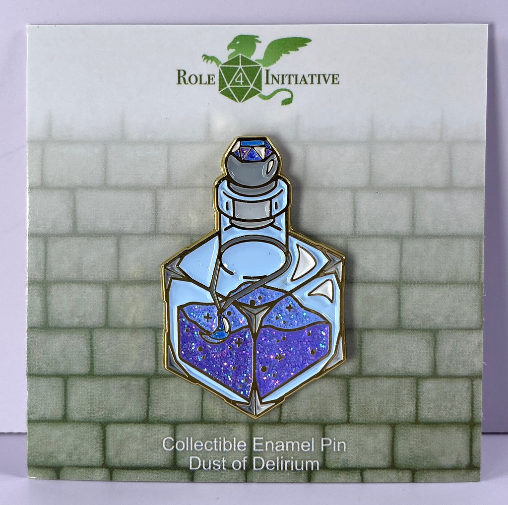 This 1.5"-tall glittering enamel pin depicts a d6-shaped magic dust bottle in crushed blue and indigo hues, with a moon shaped gem pendant hung around the bottle's neck. The vibrant colors are dressed in iridescent glitter in the dust contents, the moon pendant, and the gem encrusted in the stopper.