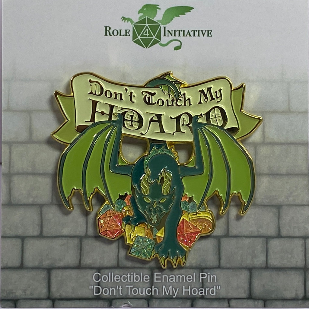 Collectible enamel pin with a dragon design and 'Don't Touch My Hoard' text on a stone wall background.