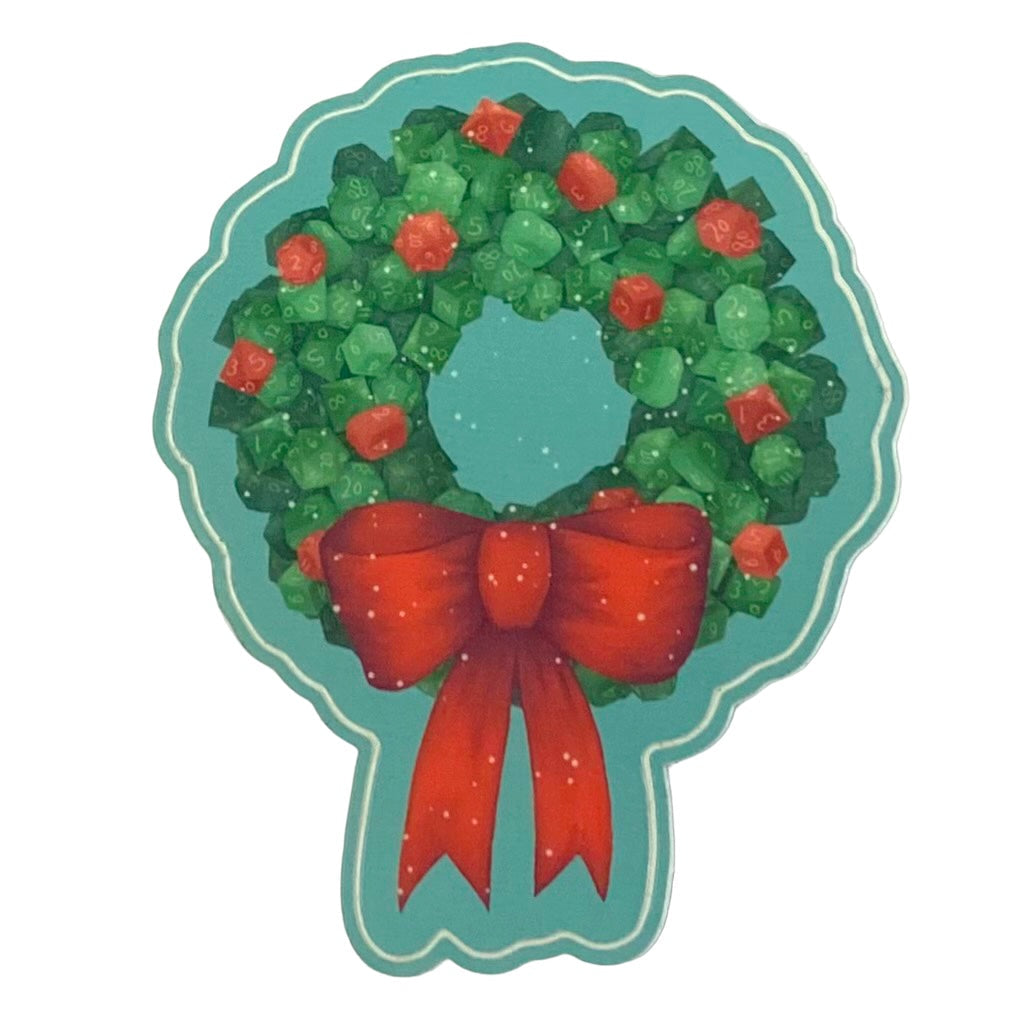 Photo shows a sticker of a holiday wreath made up of dice shapes, with red dice shaped holly berries, a red bow, and sprinkled snow.